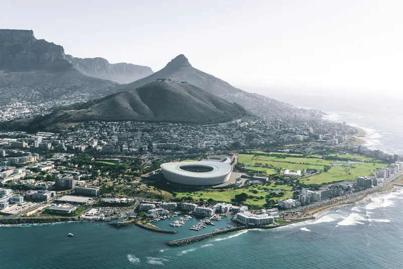 Aerial view along the Atlantic seaboard with Signal Hill, Lion's Head and the stadium below