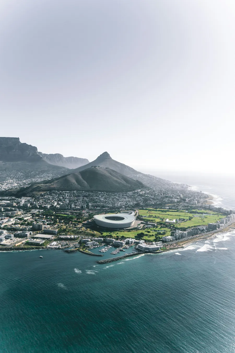Aerial view along the Atlantic seaboard with Signal Hill, Lion's Head and the stadium below